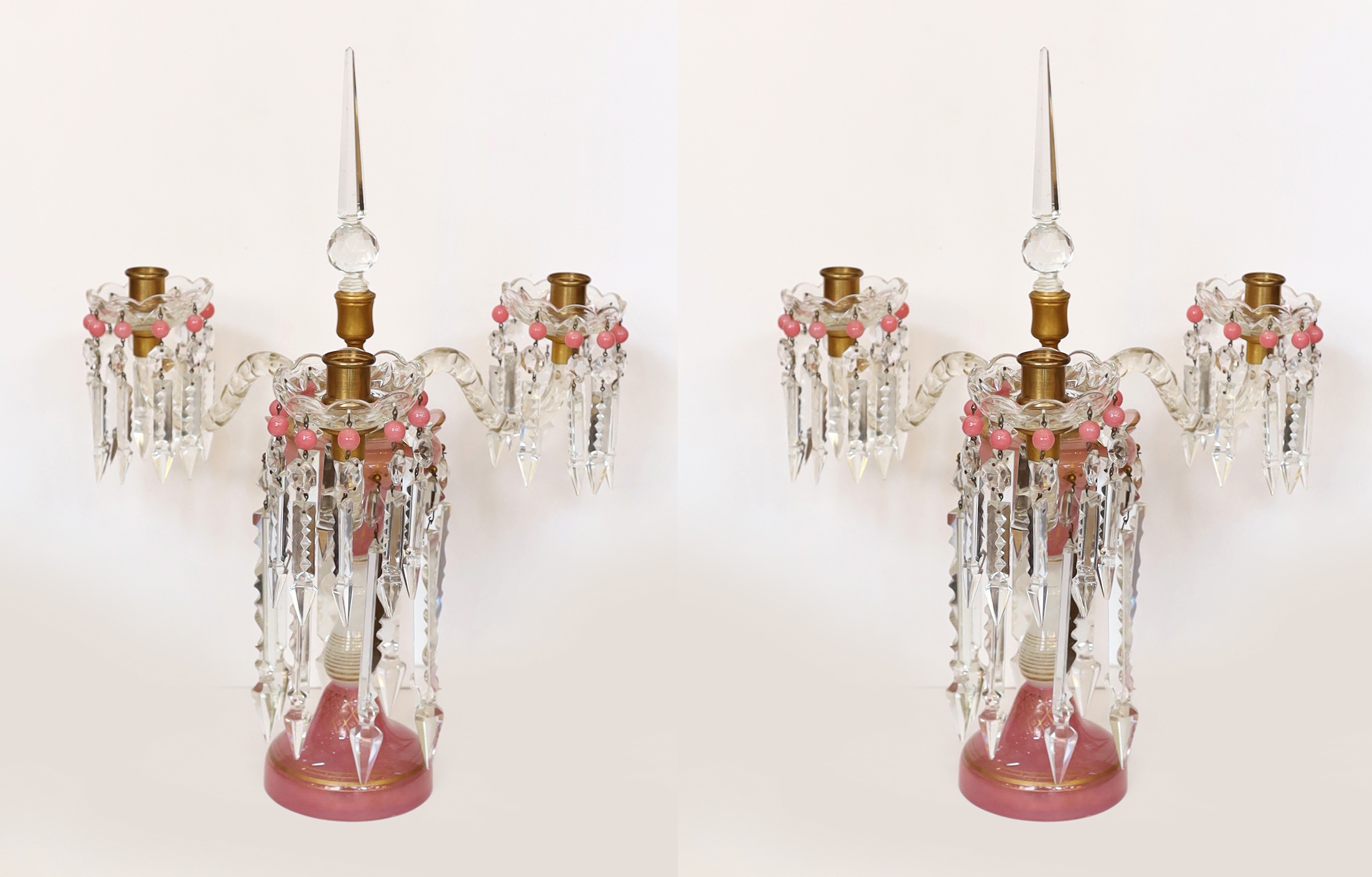 A pair of Victorian opaque pink and white glass lustre candelabra, with spear shaped finials and cut glass scrolling branches, height 52cm